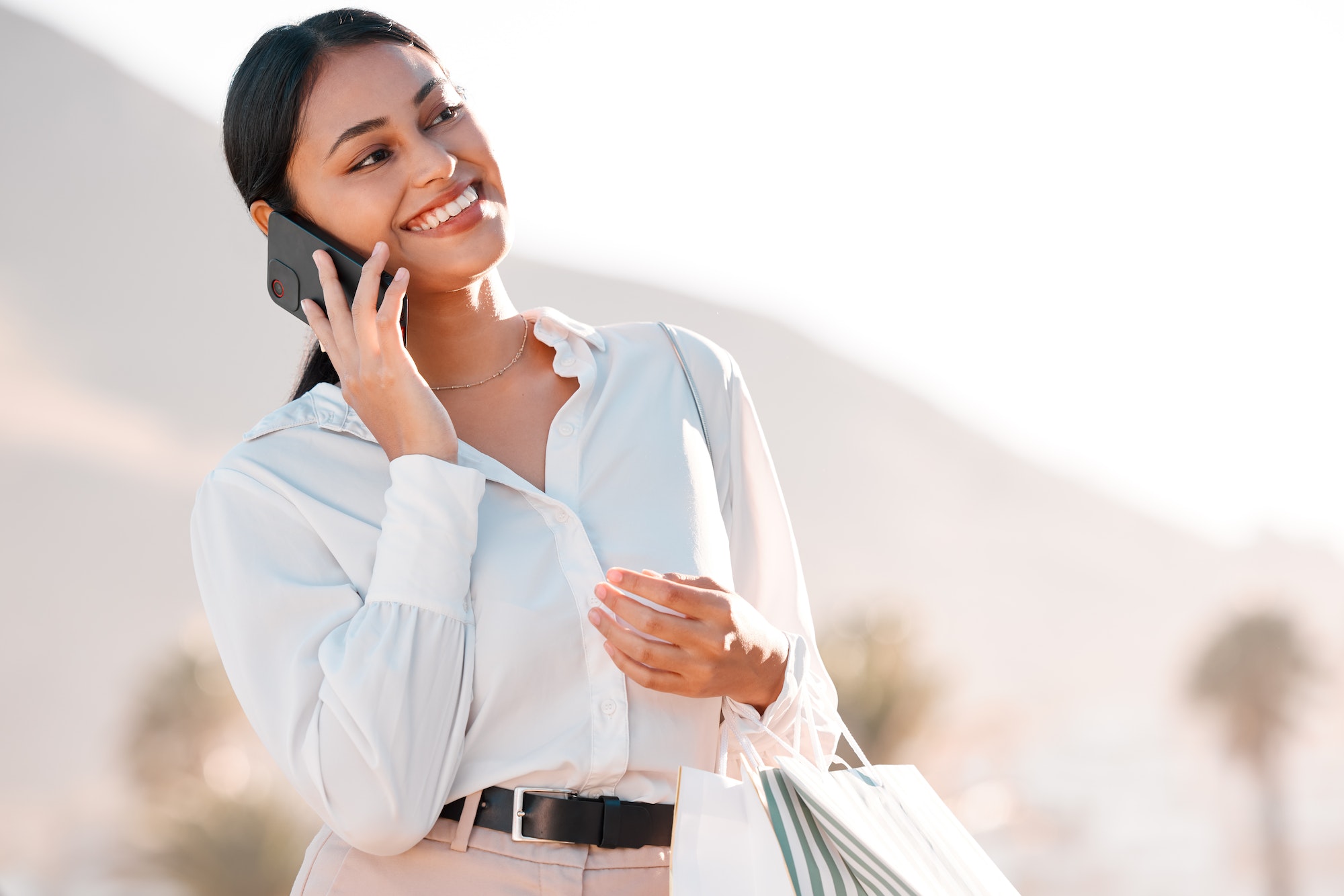 Shopping bag, phone call and woman talking to customer service for client communication, fashion or